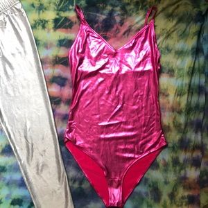 Shiny pink body suit and silver tights